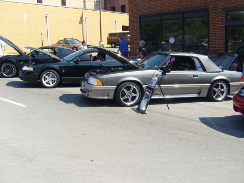 2007 Ford Mustang - A gray 1993 Ford Mustang convertible is displayed with its hood open at a car show.
