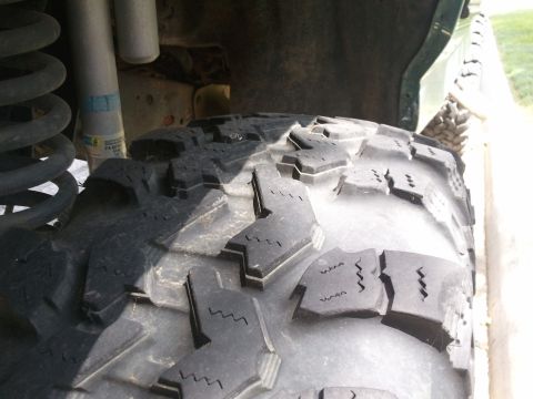 2004 Ford F-350 - The photo shows a close-up of a off-road tire and part of the vehicle's suspension system.