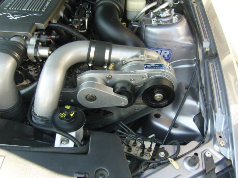 2007 Ford Mustang - Close-up view of a supercharged engine bay, highlighting the polished metal components and intricate piping.