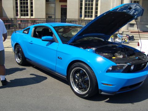 2007 Ford Mustang - Blue Ford Mustang parked outside with hood up, revealing the engine compartment.