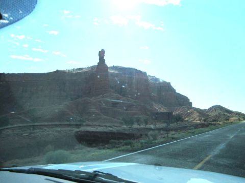 1991 Ford LTD Crown Victoria - A scenic drive through a desert landscape with a prominent rock formation visible from the road.