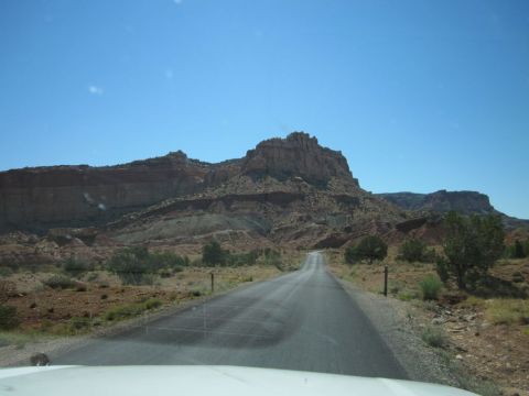 1991 Ford LTD Crown Victoria - Driving through a scenic desert landscape with vast rock formations and sparse vegetation.