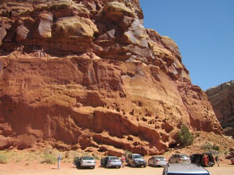 1991 Ford LTD Crown Victoria - Cars parked at the base of large red rock formations under a clear blue sky.
