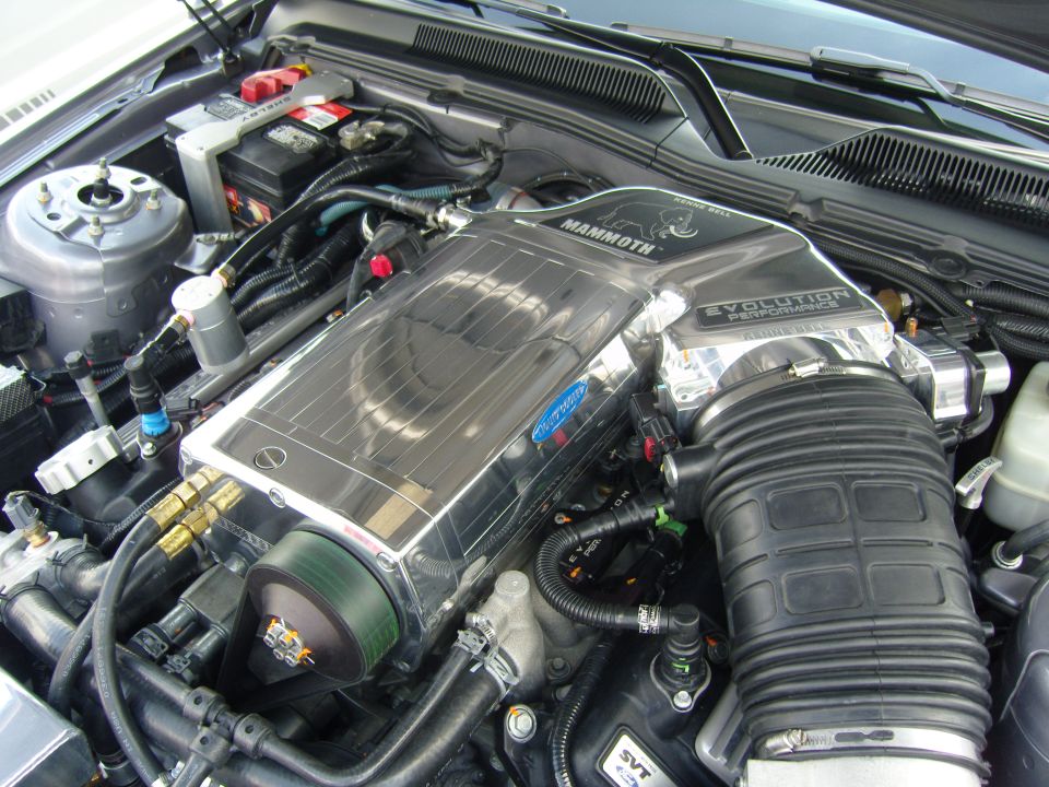 Polished supercharger with 'Mammoth' and 'Evolution Performance' labels in engine bay