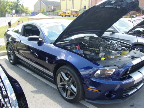 2007 Ford Mustang - 2007 Ford Mustang GT500 at a car show, hood up to display the engine.