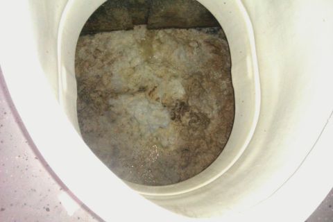 1991 Ford LTD Crown Victoria - The front wheel well of a 1991 Ford Crown Victoria is visible, showing accumulated dirt and debris.