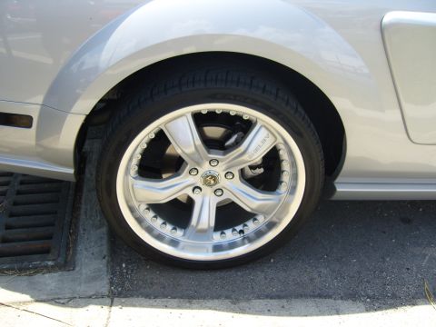 2007 Ford Mustang - Close-up of a silver Shelby wheel on a car, with visible brake components.