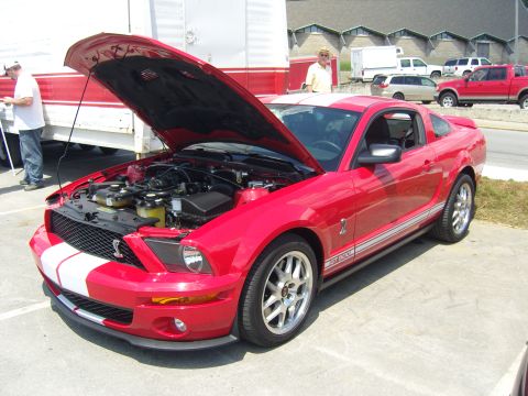 2007 Ford Mustang - Red 2007 Ford Mustang GT500 with hood open, parked outdoors.