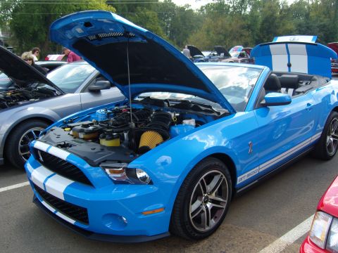 2007 Ford Mustang - Blue Ford Mustang GT 500 convertible at a car show, hood and trunk open.