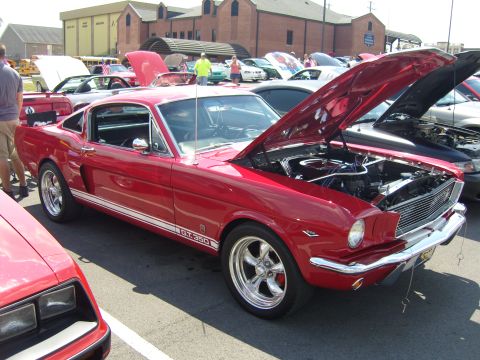 2007 Ford Mustang - Classic red 1966 Ford Mustang GT 350 on display with its hood up.