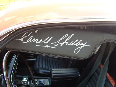 2007 Ford Mustang - A sun visor inside a car features a prominent "Carroll Shelby" signature in white script.