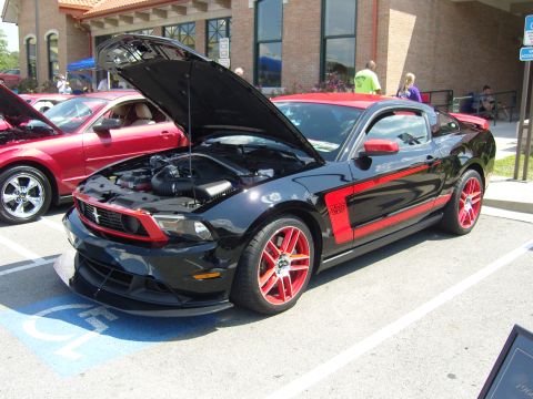 2007 Ford Mustang - A black Ford Mustang Boss 302 with red accents is displayed with its hood open.