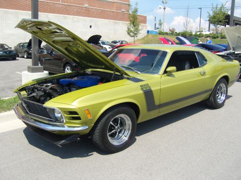 2007 Ford Mustang - A lime green 1970 Ford Mustang Boss 302 is displayed with its hood open at a car show.