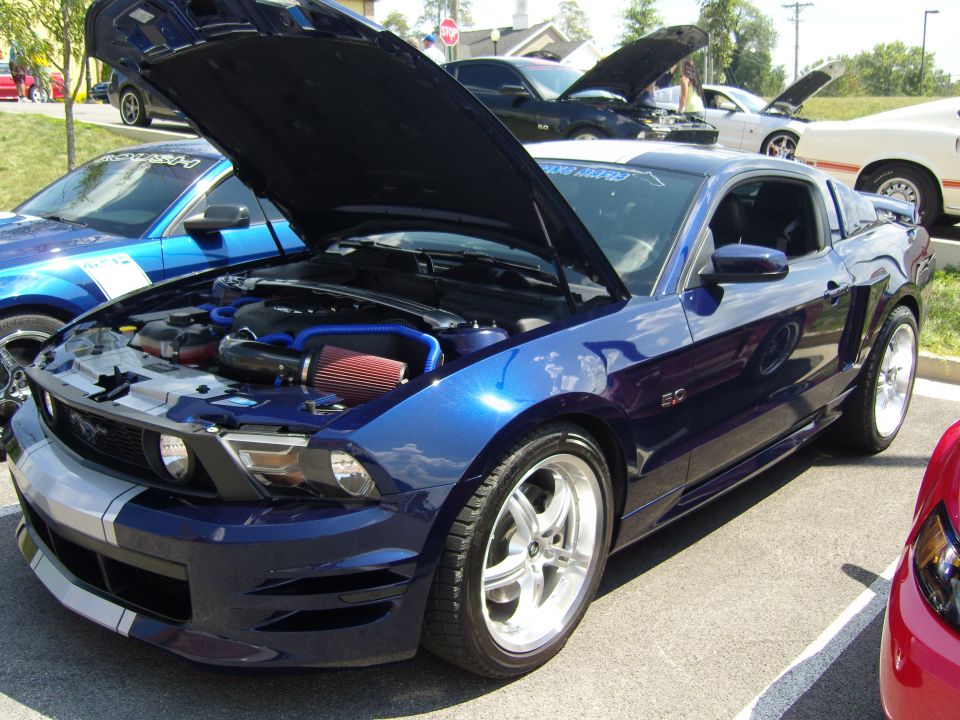 Blue 2007 Ford Mustang with hood open, showing engine and silver racing stripes