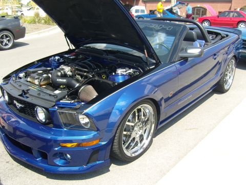 2007 Ford Mustang - Blue 2007 Ford Mustang convertible at a car show, hood up to display the engine.