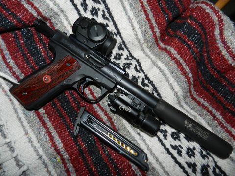 1996 Ford Bronco - This firearm has a suppressor and a tactical light attached, along with an optic sight.