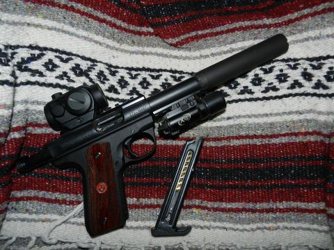 1996 Ford Bronco - A pistol with accessories is laid out on a patterned blanket.
