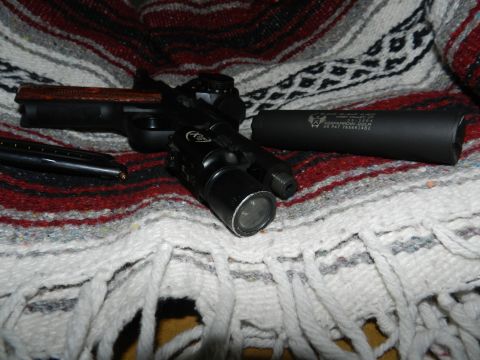 1996 Ford Bronco - A handgun with accessories is displayed on a patterned blanket.