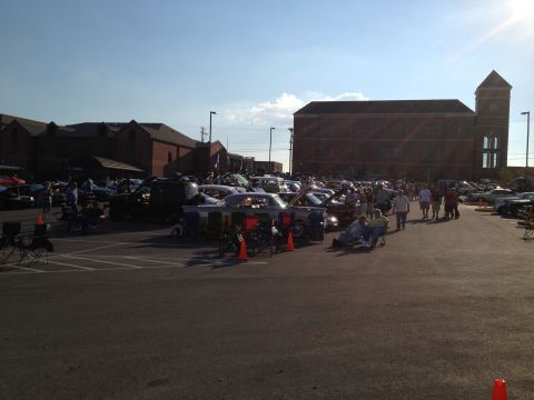 2007 Ford Mustang - A car show is underway with numerous vehicles and attendees enjoying the outdoor event.