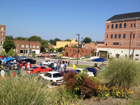 2007 Ford Mustang - A gathering of cars and people at an outdoor event, with buildings visible in the background.