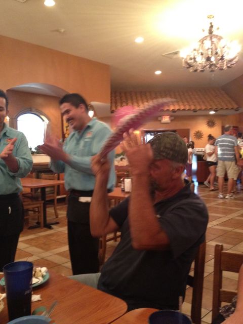 2007 Ford Mustang - People are celebrating in a restaurant with a man holding a sombrero.