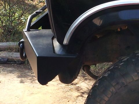 1986 Ford Bronco - Close-up of the rear bumper and tire, showing off-road modifications.