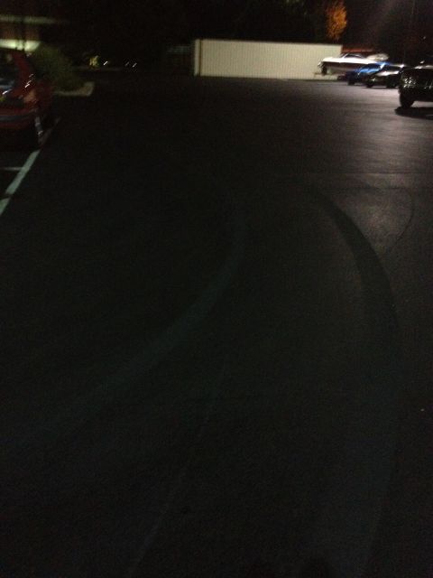 2007 Ford Mustang - A dark parking lot scene at night with several vehicles visible.
