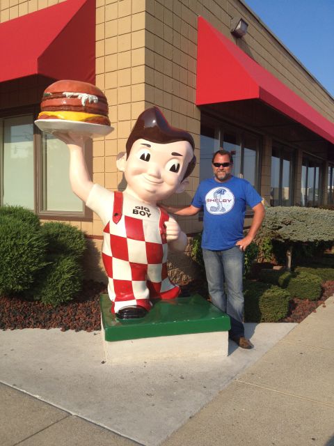 2007 Ford Mustang - A man poses with a Big Boy statue outside a restaurant, wearing a blue shirt with a Shelby logo.