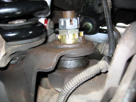 1996 Ford Bronco - Close-up of a vehicle's ball joint assembly, including suspension parts and hardware.