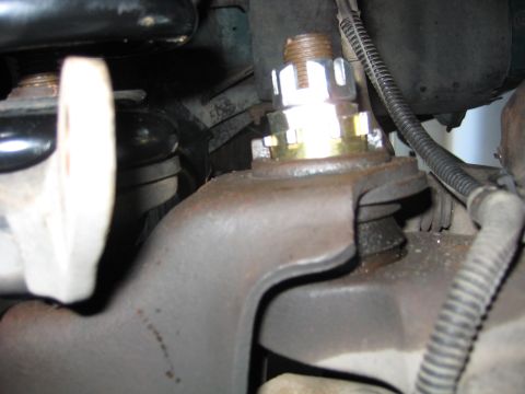 1996 Ford Bronco - This image shows a close-up view of a suspension component, specifically a castle nut and bolt assembly.