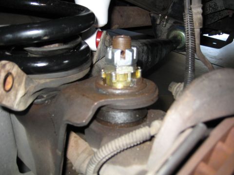 1996 Ford Bronco - This image shows a close-up view of a vehicle's ball joint assembly and surrounding suspension parts.