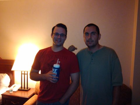 1993 Ford Probe - Two men pose for a photo in a room with a lamp and a bed in the background.