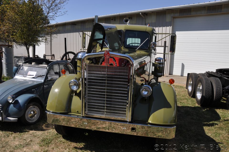 Green 1959 Kenworth W900A truck front view with chrome grille