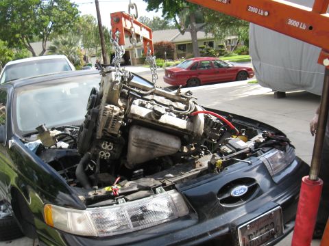 1992 Ford Taurus - Engine hoist lifting the engine out of a 1992 Ford Taurus.