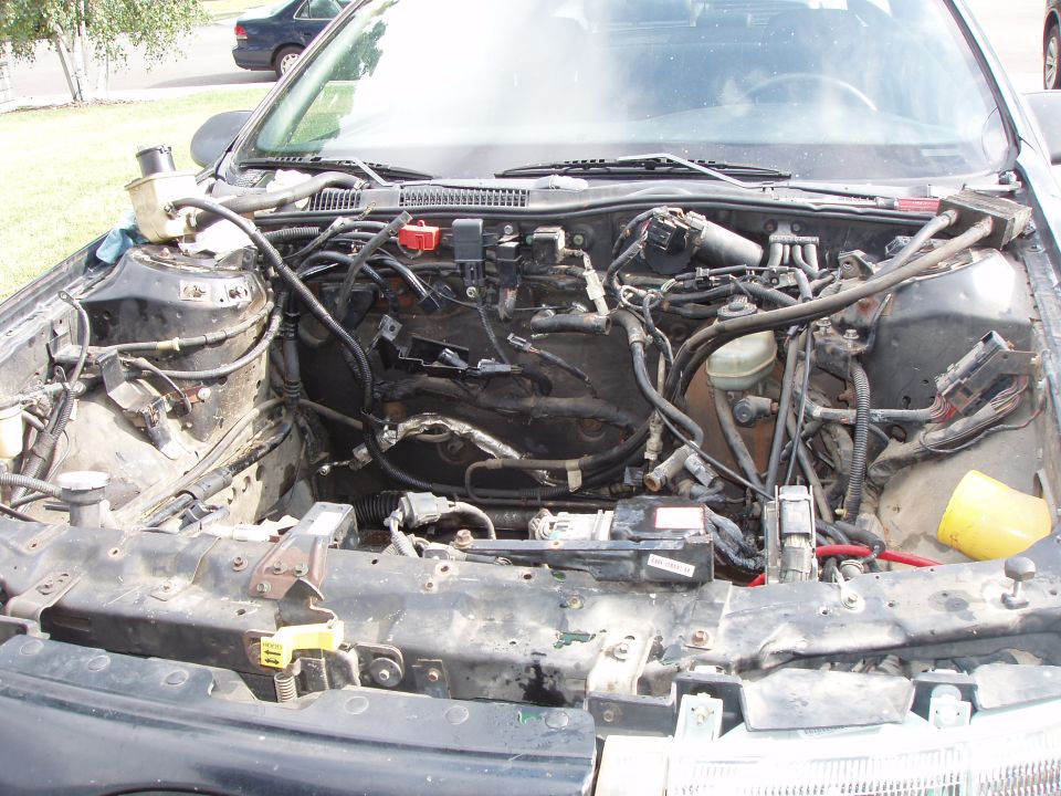 Engine bay with wiring and components visible, no engine present