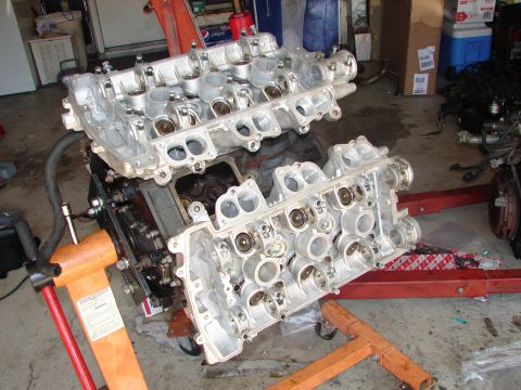 1992 Ford Taurus - V6 engine cylinder heads are shown disassembled on engine stands.