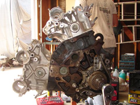 1992 Ford Taurus - Engine block and cylinder head assembly, partially disassembled, with tools and supplies in the background.