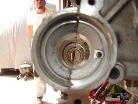 1992 Ford Taurus - A person stands behind a disassembled engine block, showing the internal cylindrical passage.