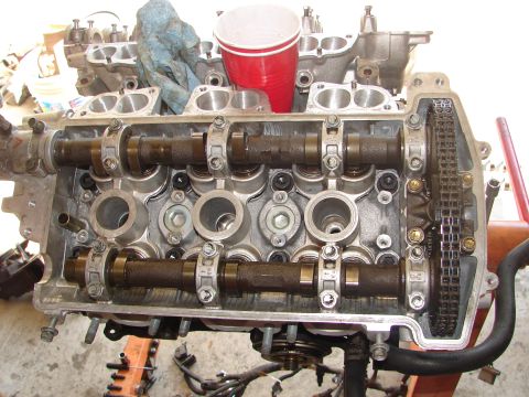 1992 Ford Taurus - Close-up view of an engine's cylinder head, showing internal components like camshafts and valves.