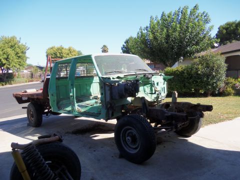 1968 Ford Bronco - This green truck chassis is being worked on, with the engine and body panels removed.