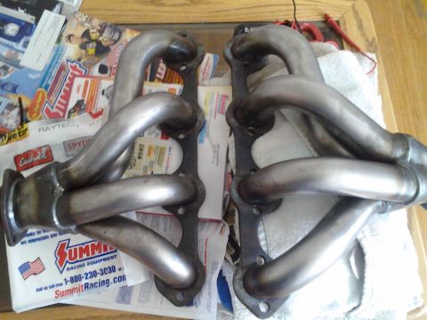 1968 Ford Bronco - Exhaust headers are shown laid out on a table, with various automotive magazines and a Summit Racing bag visible.