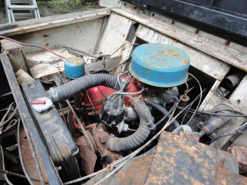 1962 International Scout 80 - The engine bay of a vehicle, showing the air filter, engine block, and radiator.