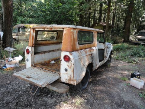 1962 International Scout 80 - This weathered 1962 International Scout 80 sits in a wooded area with its tailgate open.