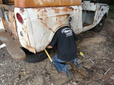 1962 International Scout 80 - Working on the rear axle of a 1962 International Scout 80. Tools are laid out nearby.