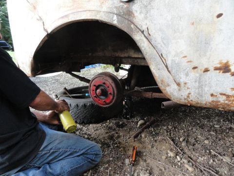 1962 International Scout 80 - Working on the rear drum brake assembly of a vintage vehicle.