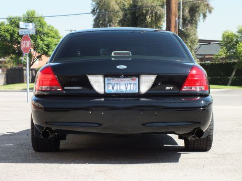 2003 Ford Crown Victoria - Straight rear view of a black Crown Victoria with EVIL VIC plate in a Crown Victoria frame and SVT badge.