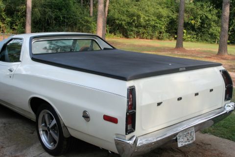 1976 Ford Ranchero - Rear view of a white 1976 Ford Ranchero pickup truck with a soft bed cover.