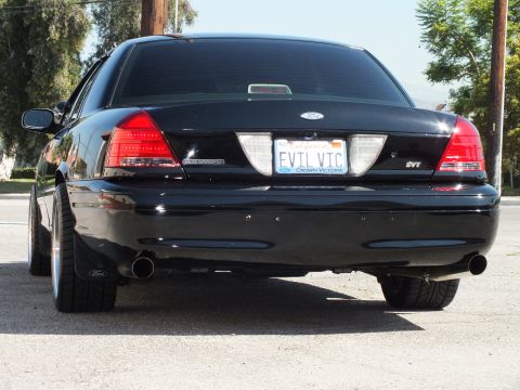 2003 Ford Crown Victoria - Rear of a black Crown Victoria showing SVT badge and EVIL VIC plate in a Crown Victoria frame.