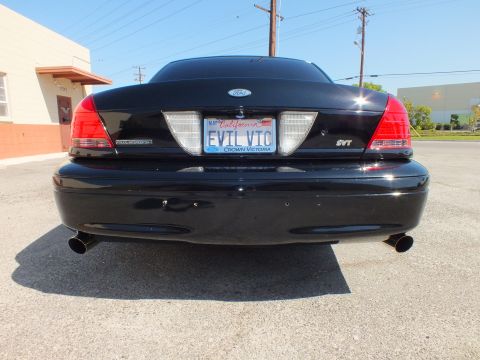 2003 Ford Crown Victoria - Straight-on rear of the black Crown Victoria; Ford oval, SVT badge, dual tips and EVIL VIC plate.