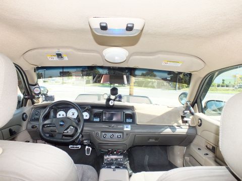 2003 Ford Crown Victoria - Front cabin of the Crown Victoria with Ford wheel, white-face gauges and overhead console.